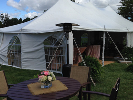 outside of the tent rental views looking in grass pavement tables chairs 
