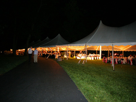outside of the tent rental views looking in grass pavement tables chairs 